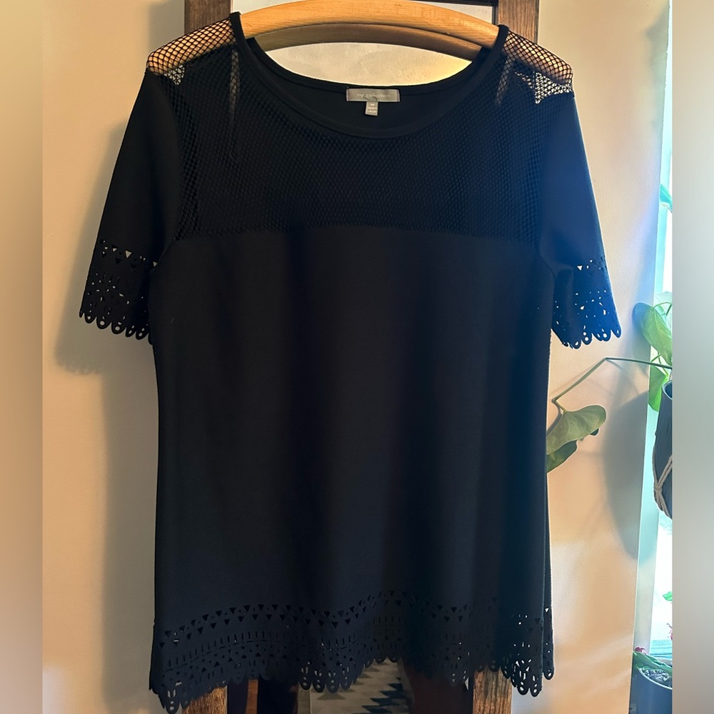 Black short sleeved top with detailed neckline, sleeves and waist